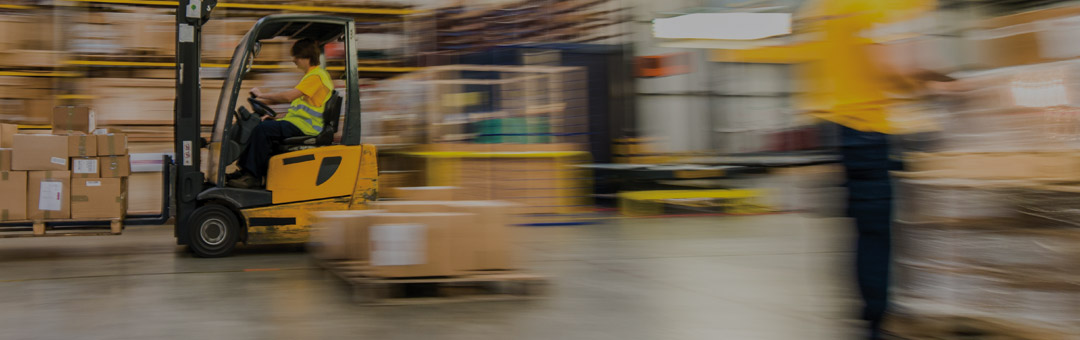 Warehouse worker operating forklift